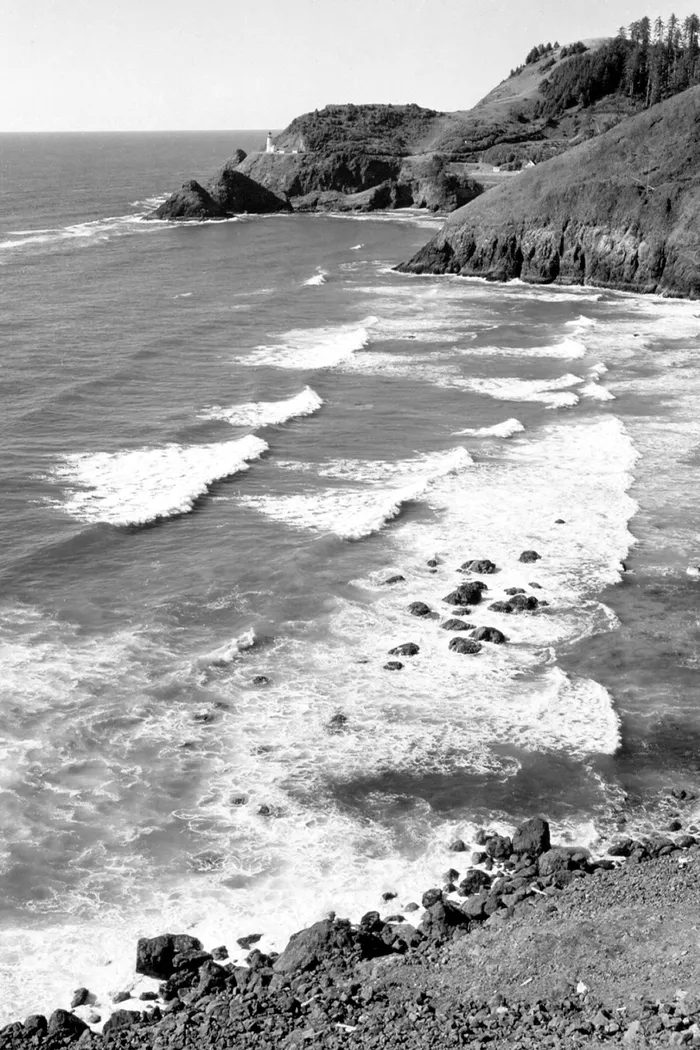 Black-and-white photograph: Oregon Coast Lighthouse, 1940s. Location: Oregon Coast. Date: c. 1940s.