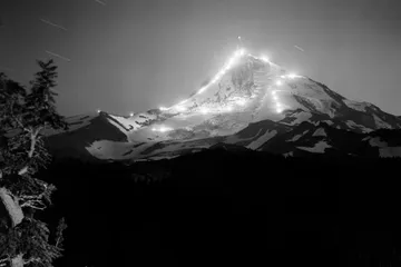 Black-and-white photograph: Night Skiers with Flares, Mt. Hood. Location: Mt. Hood, Oregon.