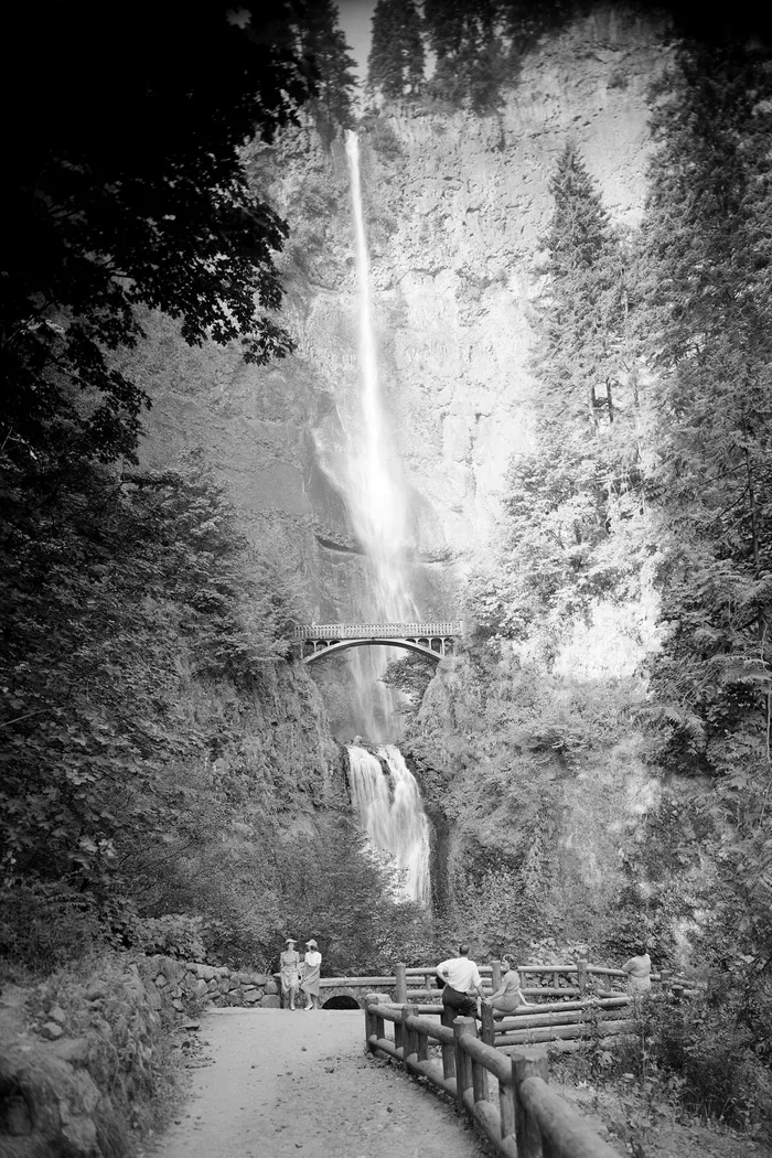 Black-and-white photograph: Multnomah Falls. Location: Multnomah Falls, Columbia River Gorge, Oregon.